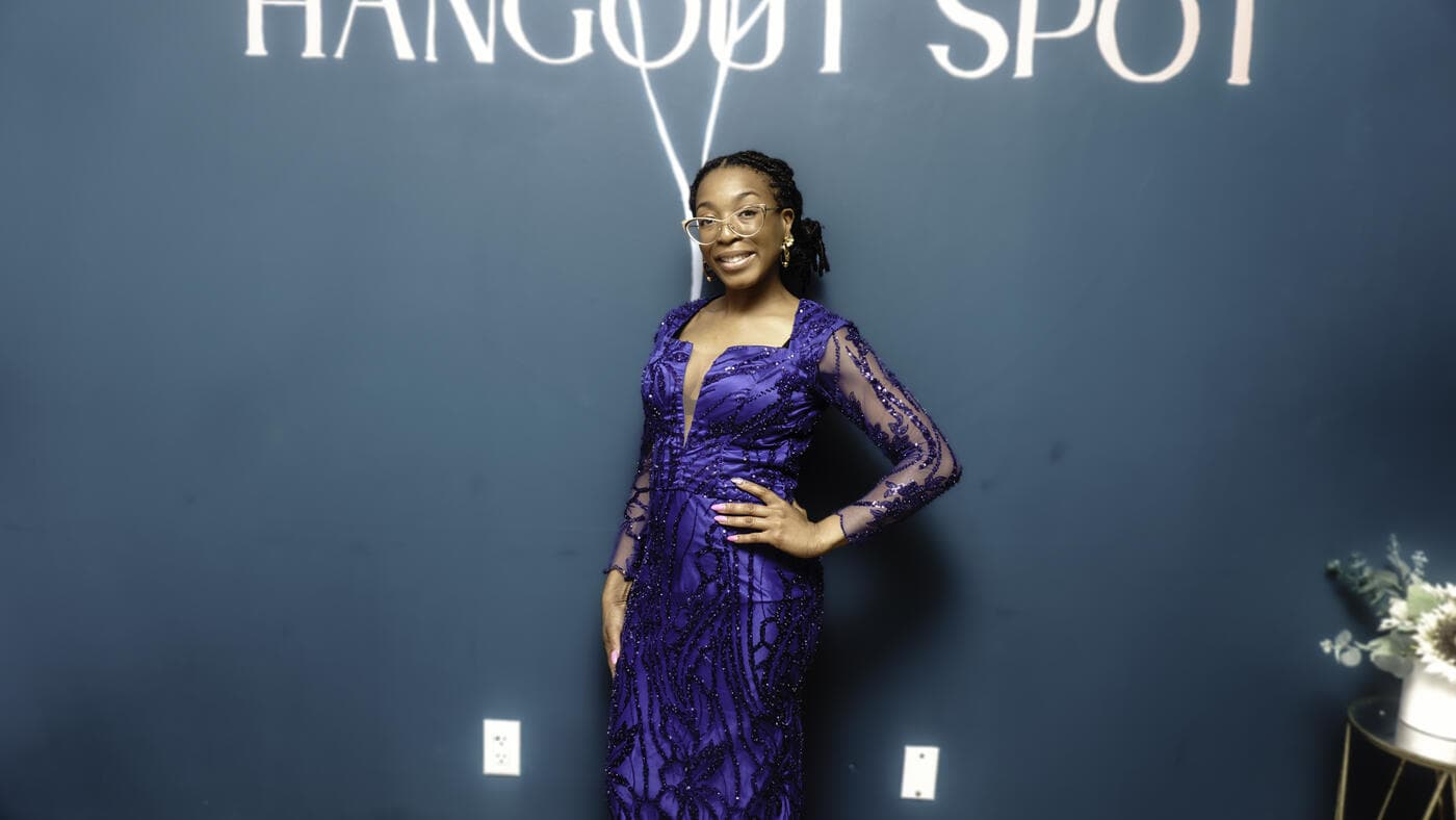 A guest in a purple lace gown at Gala Night