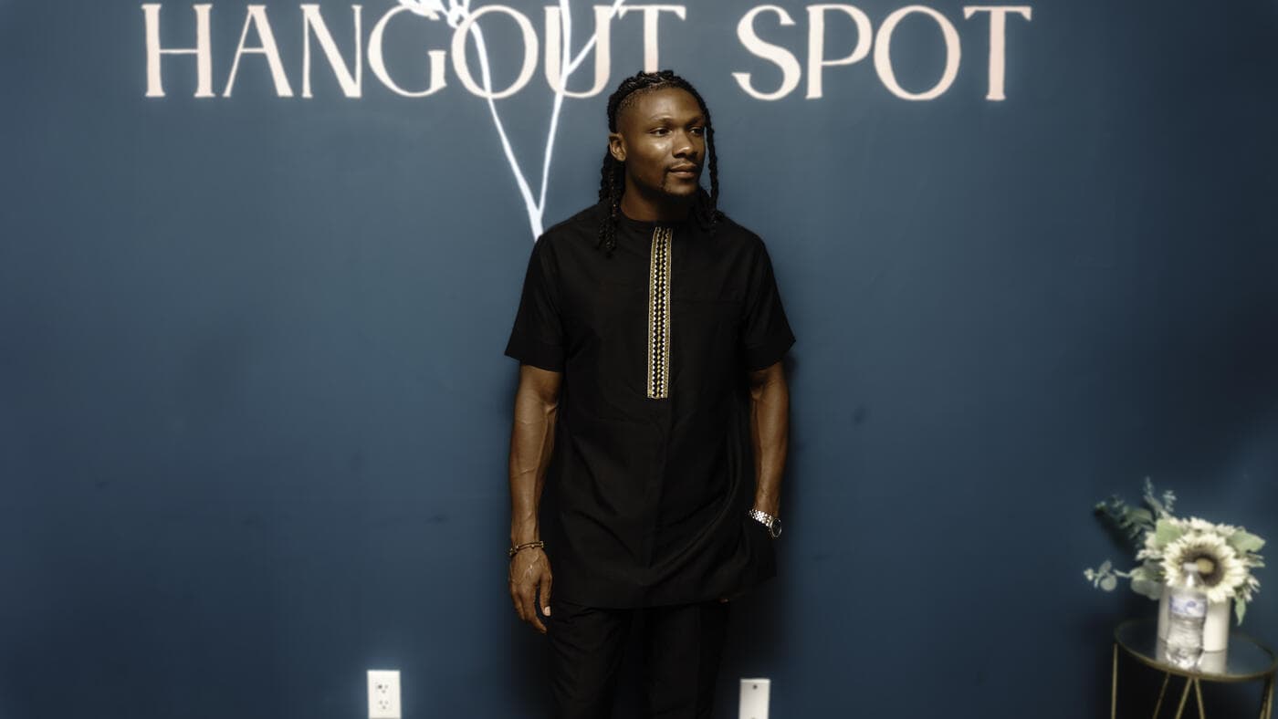 A guest in black traditional wear with gold detail at Gala Night